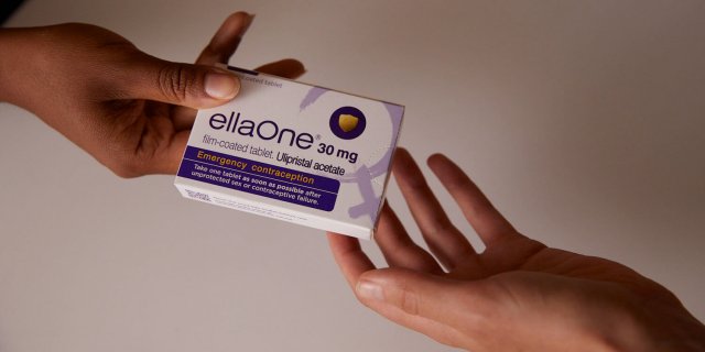 Hands holding a pack of ellaOne