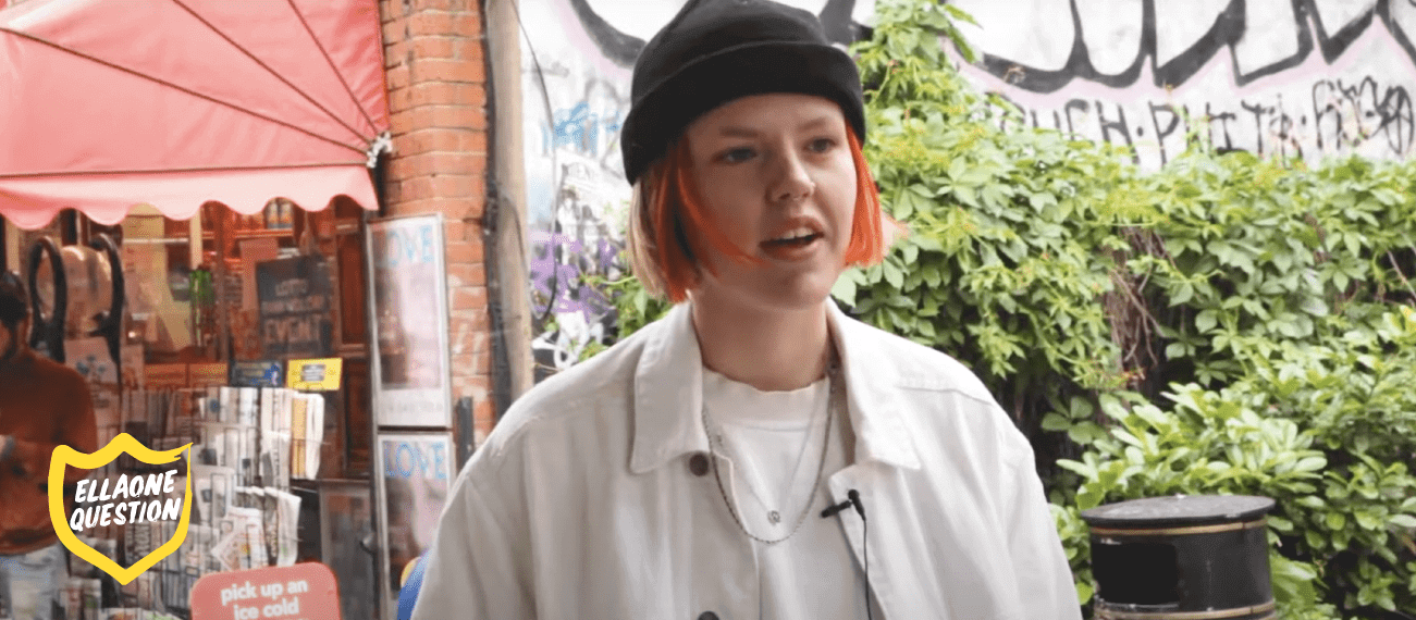 "ellaOne question - woman with short red hair on street"