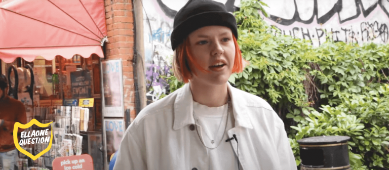 "ellaOne question - woman with short red hair on street"