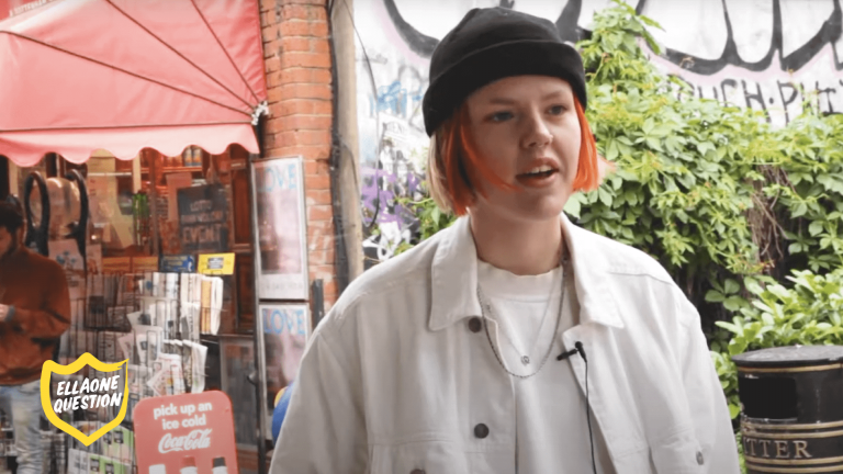 "ellaOne question - woman with short red hair on street"
