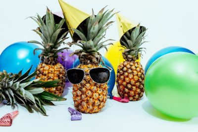 Pineapple with sunglasses and party hat